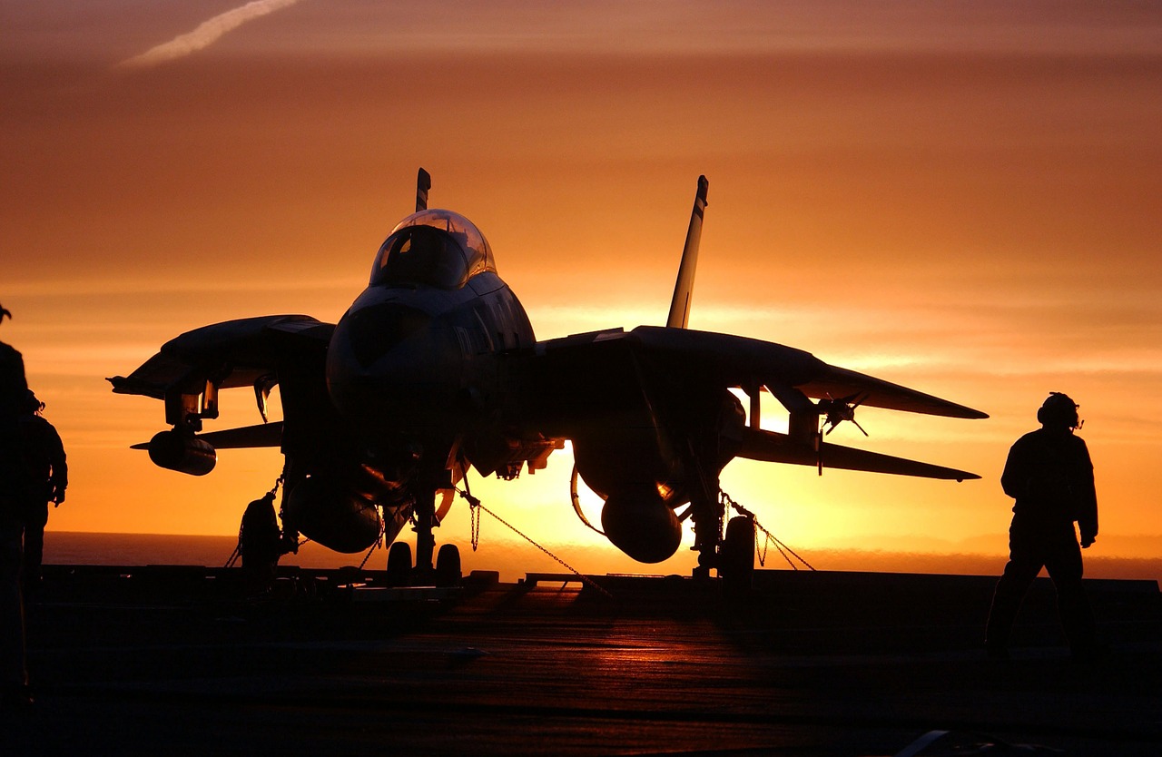 Military jet on the ground at sunset