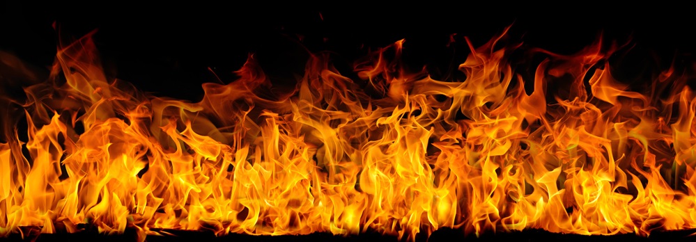 Bright fire flames against a black background